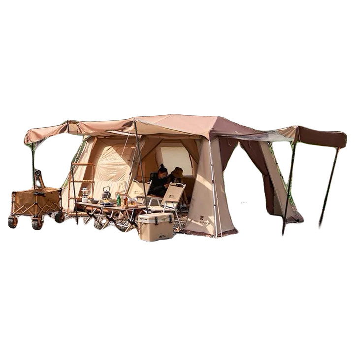 Large tan cabin-style camping tent set up with an extended awning, chairs and camping equipment