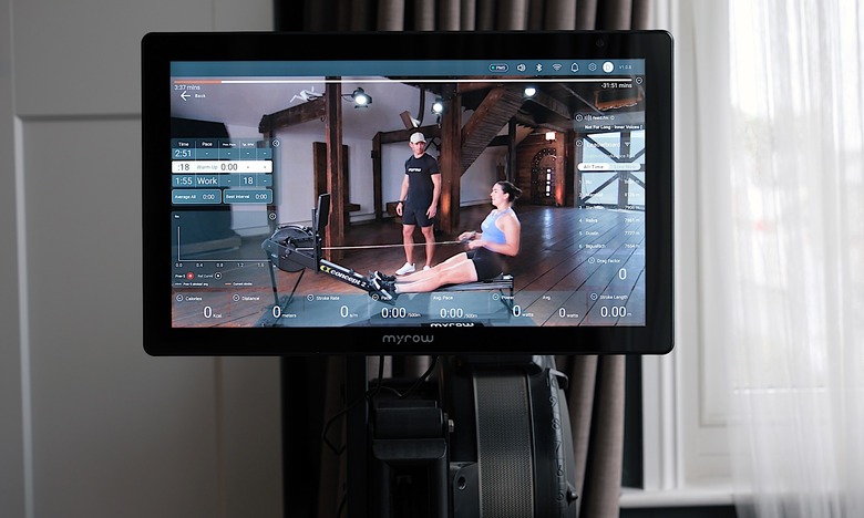 MyRow display mounted above a Concept2 rowing machine in use