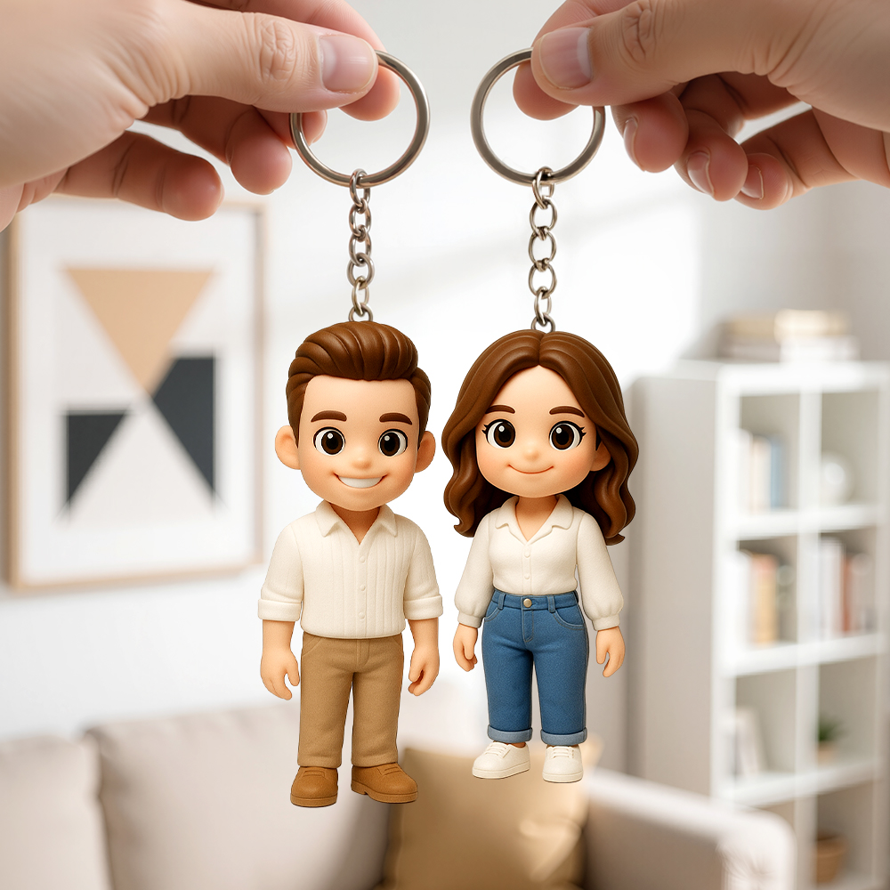 Hands holding a pair of personalized character keychains