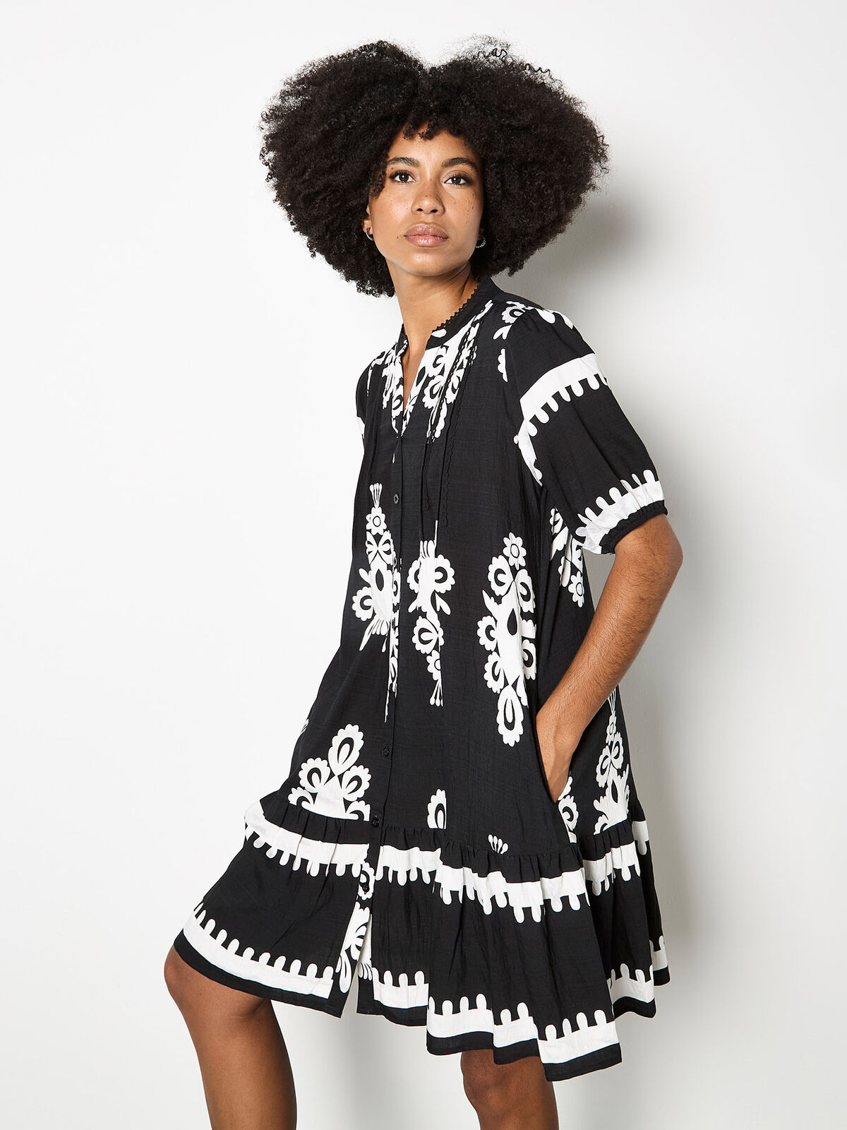 Model wearing a black-and-white baroque-print shirt dress from Apricot