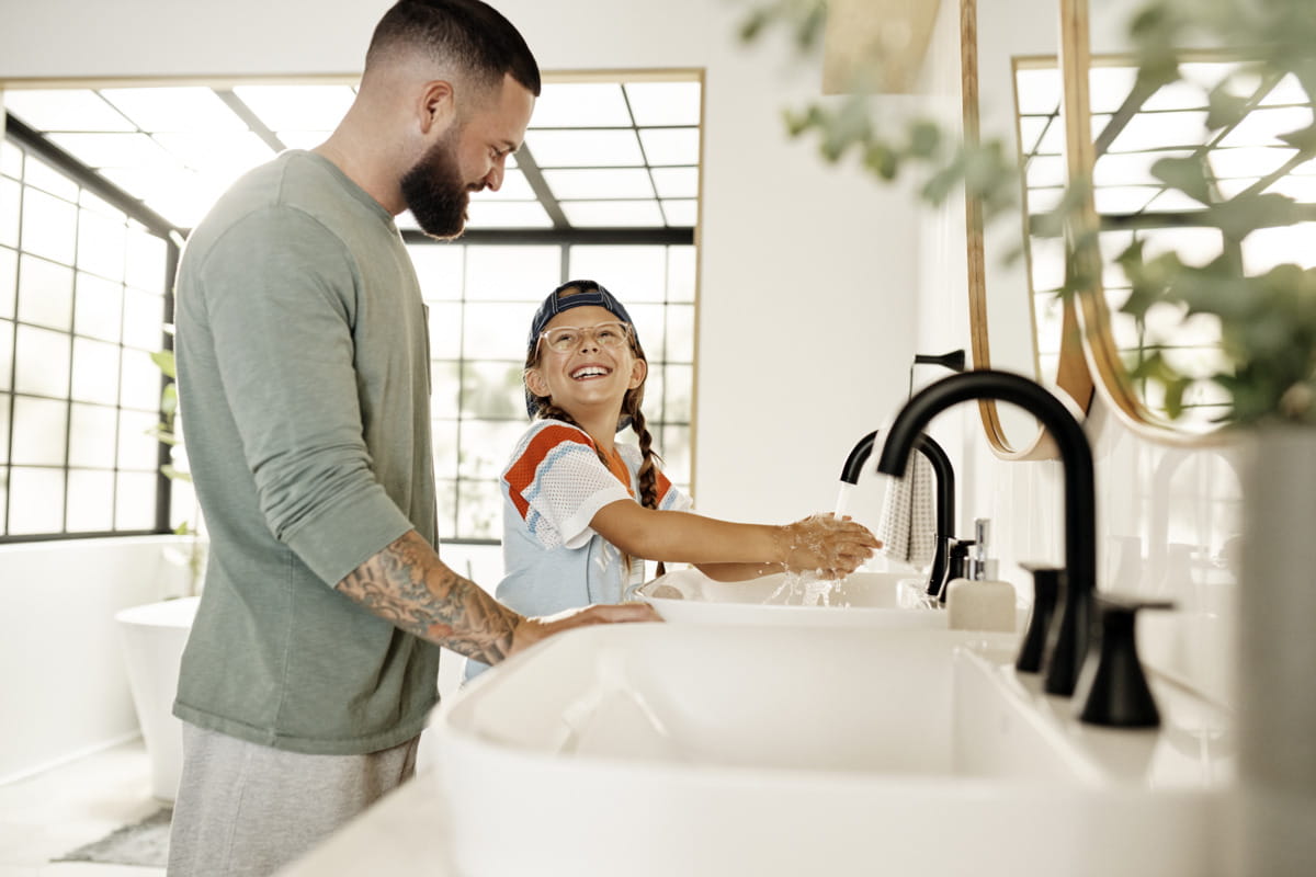 Family using a matte black faucet in a bright modern bathroom