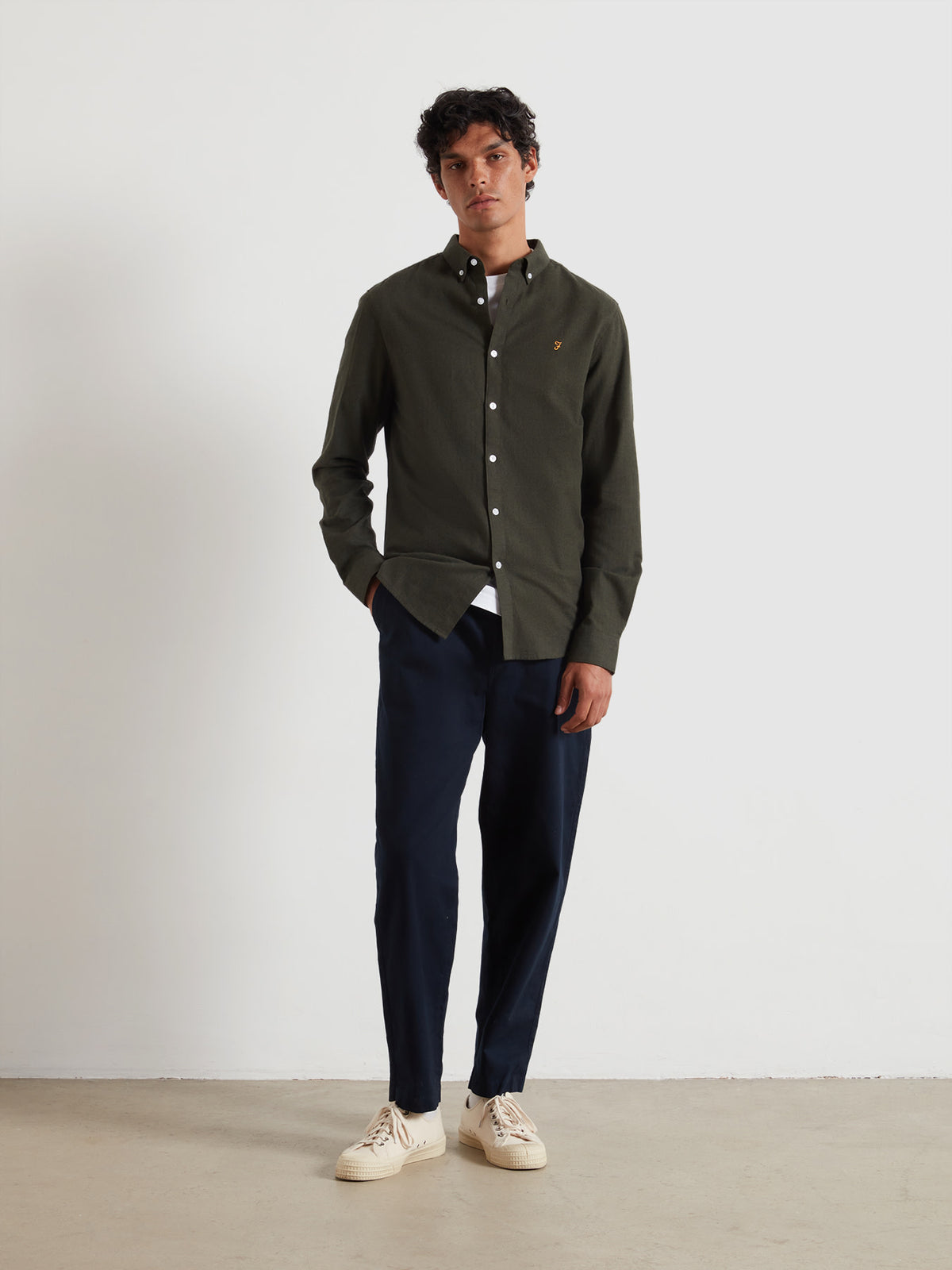 Model wearing a dark Farah menswear outfit with navy trousers