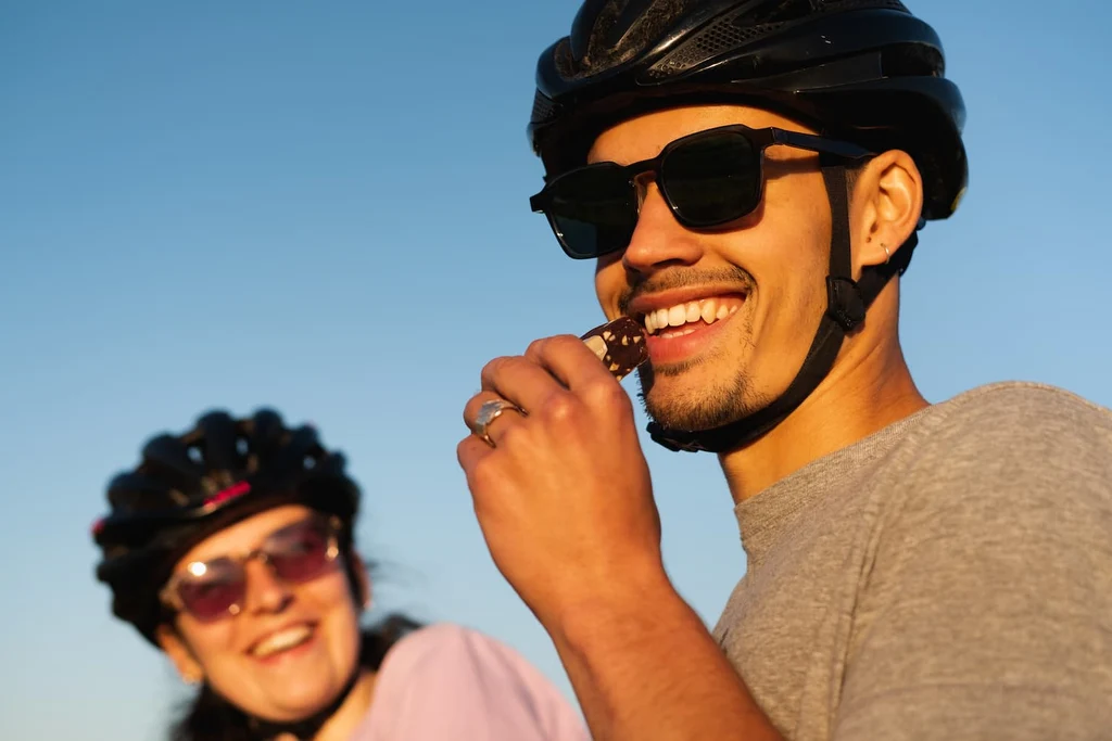 Cyclists eating a Veloforte energy bar during a ride