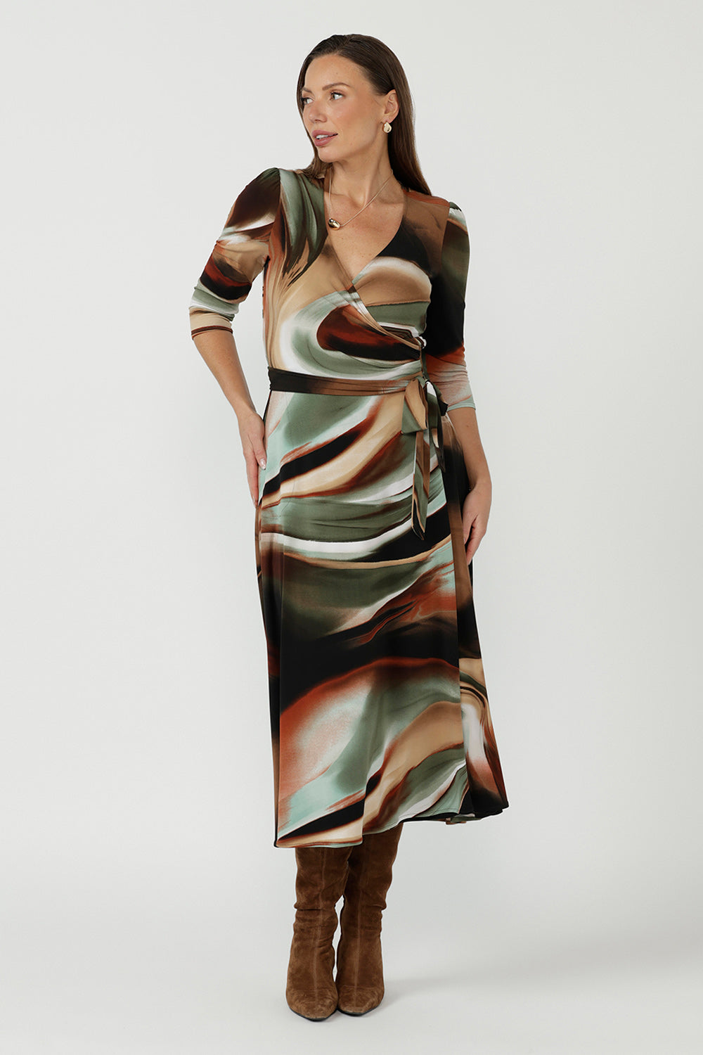 Woman modelling a long striped wrap dress in brown, cream, teal and rust tones