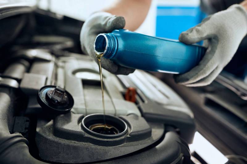 Engine oil being added to a car for routine maintenance