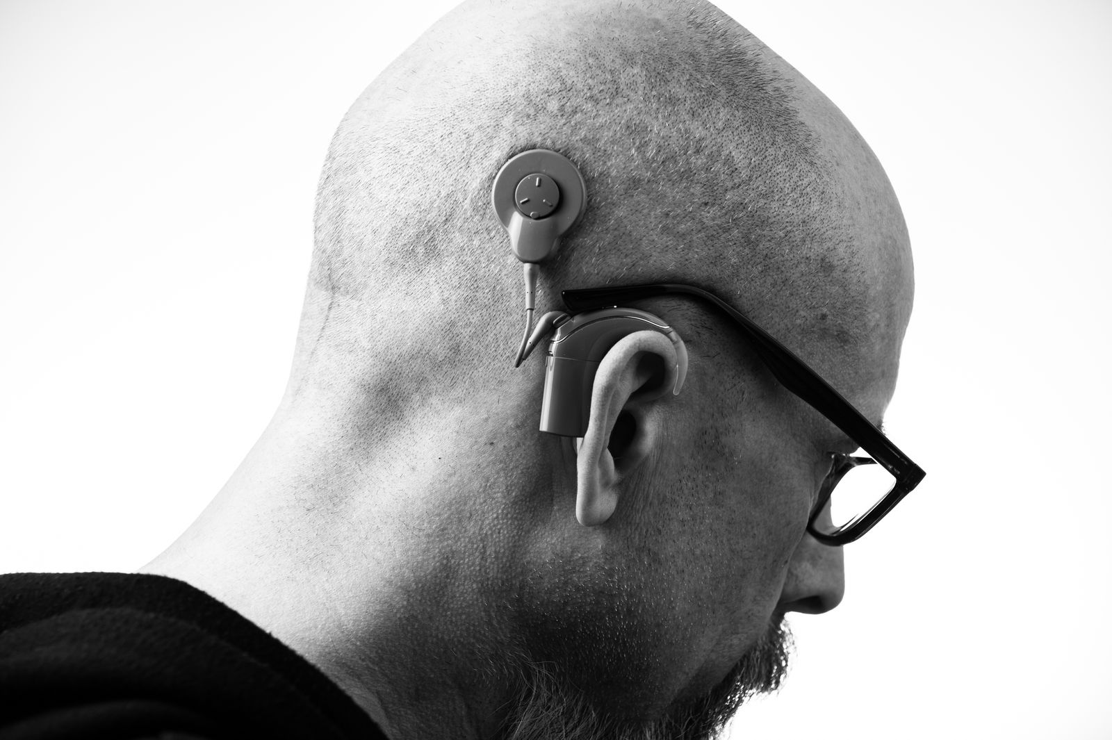 Older man wearing a behind-the-ear hearing aid
