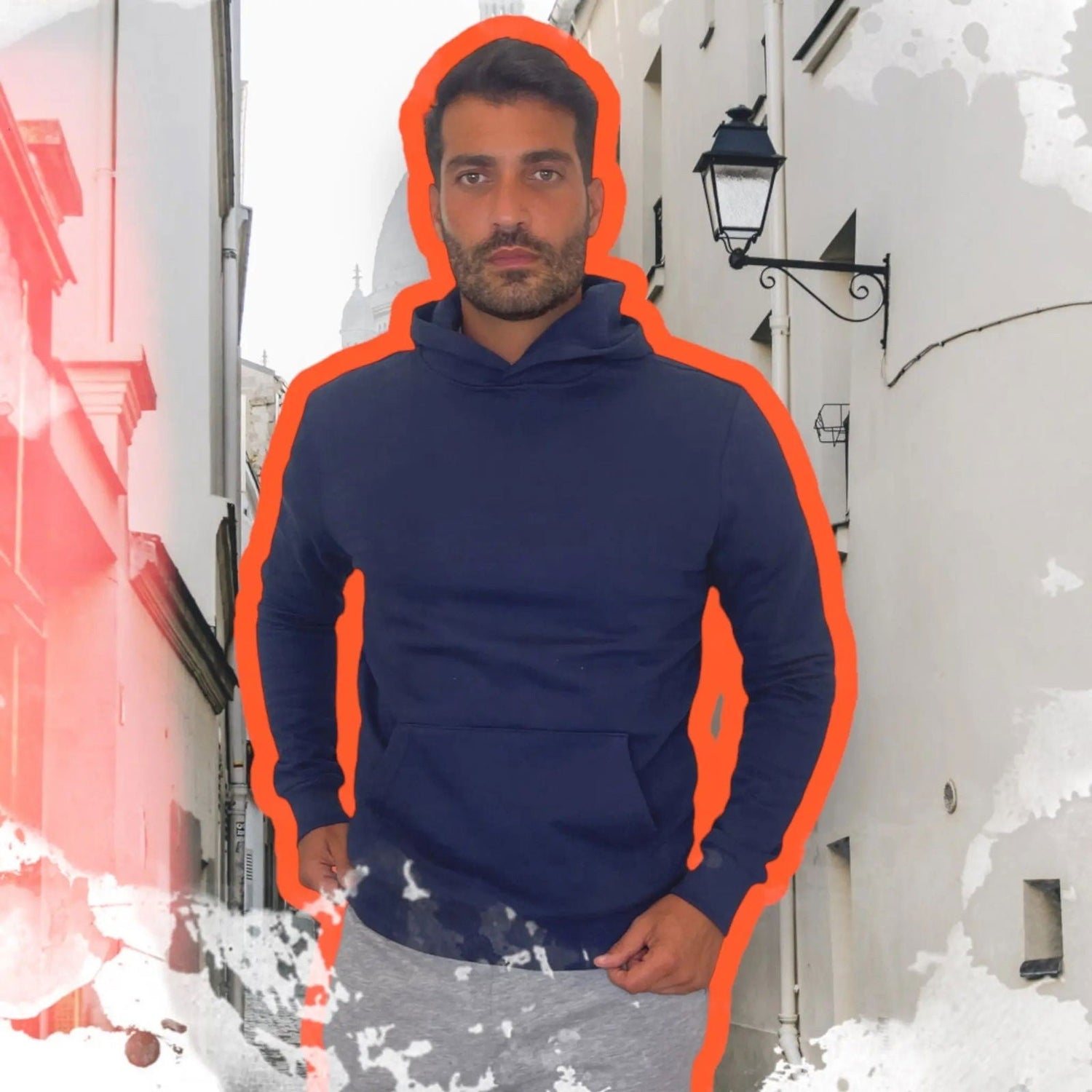 Man wearing a navy sweatshirt in a bright clothing studio