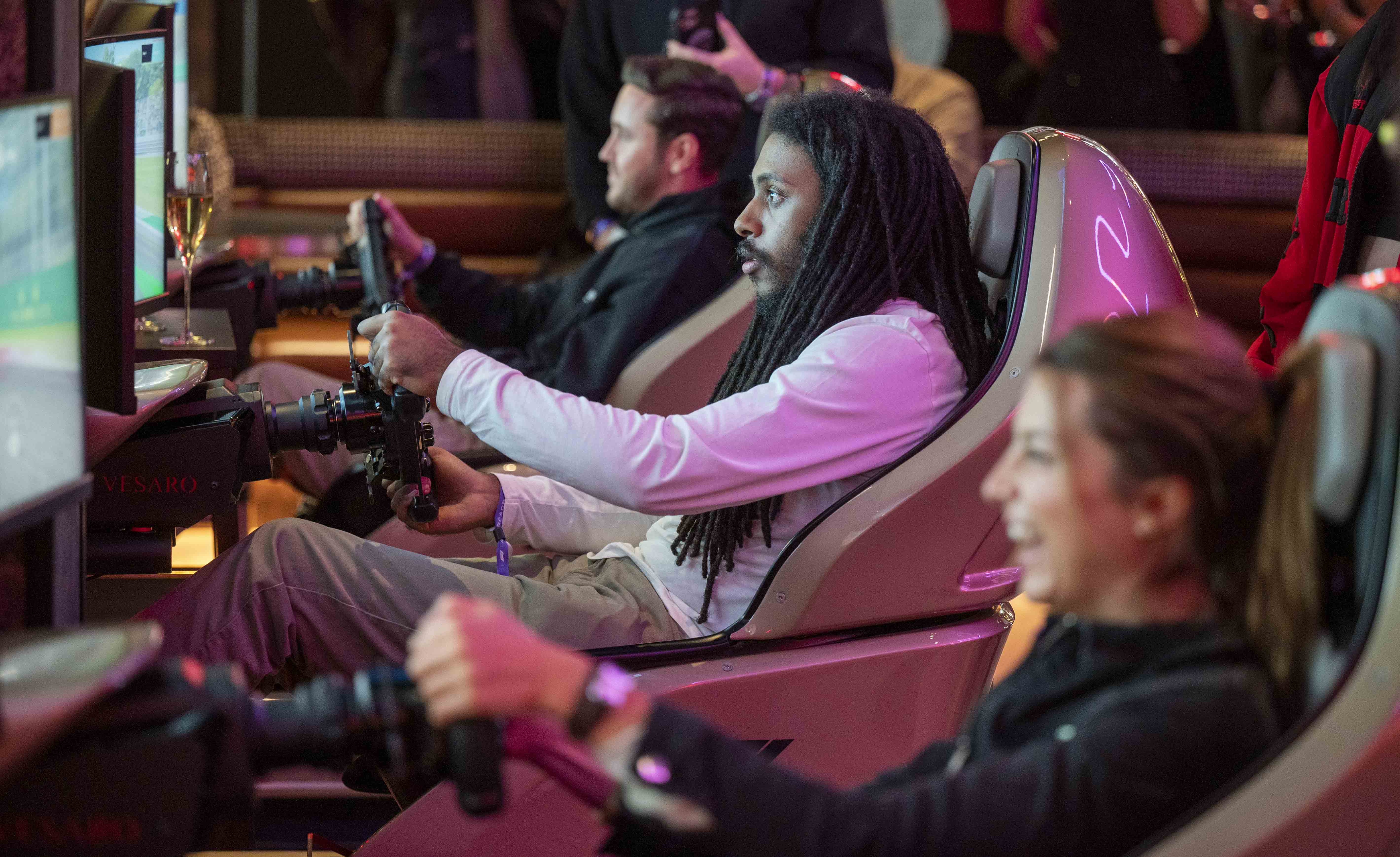 Group sim racing together at F1 Arcade