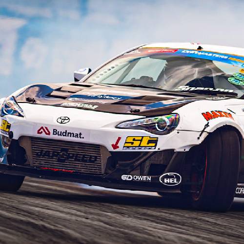 Japspeed-liveried drift car corners on a race track