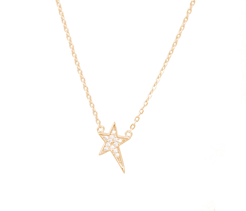 A delicate gold necklace with an open star pendant on a white background