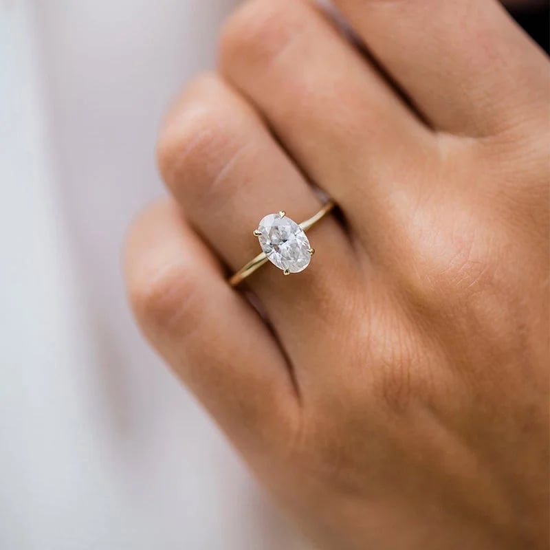 Lane Woods solitaire moissanite ring worn on a person's hand