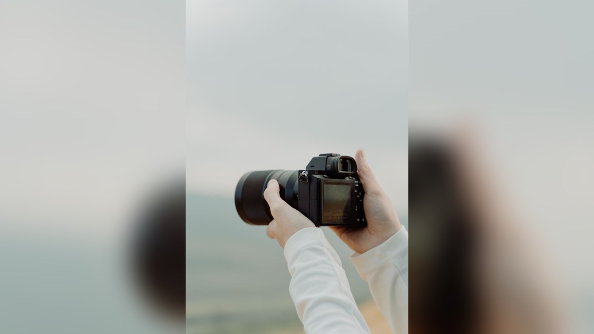 Illustrative stock photograph of a digital camera in use