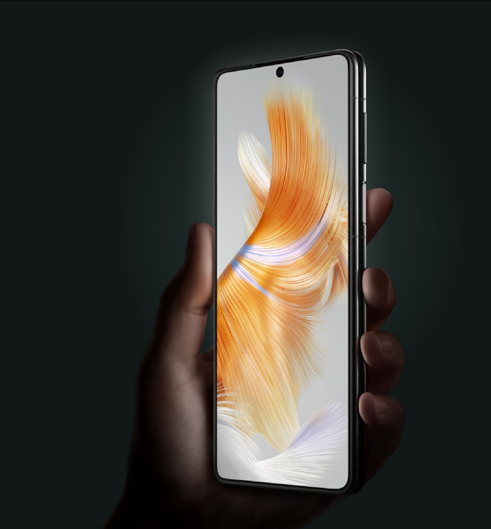 Hand holding an unfolded Huawei Mate X3 smartphone against a dark background