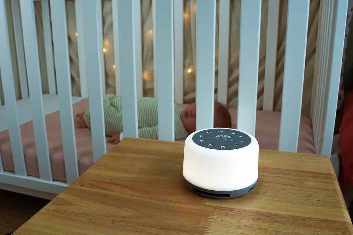 Zello Sleep white-noise machine beside a baby's cot