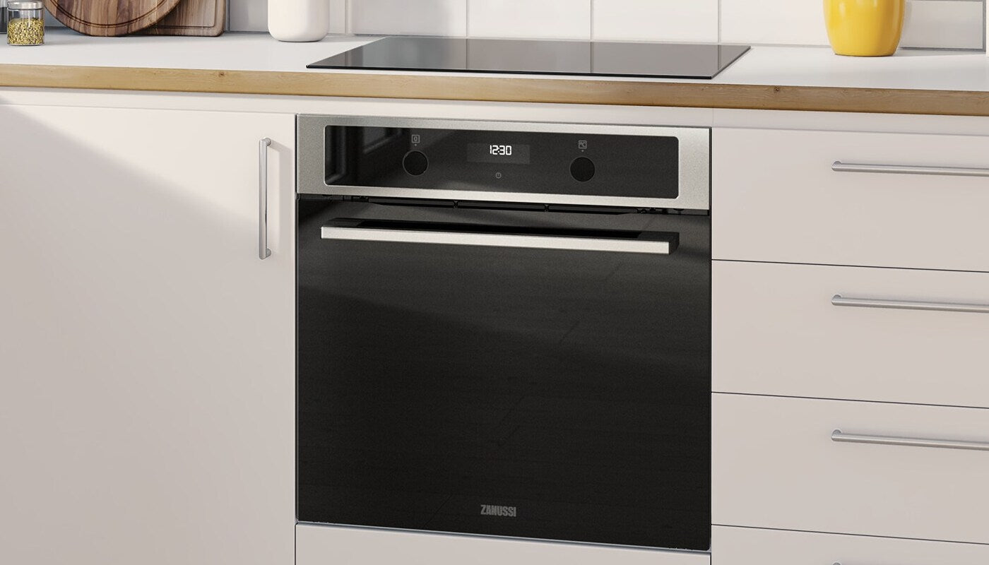 Built-in Zanussi oven and induction hob in a modern white kitchen
