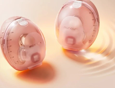 Parent using a Momcozy wearable breast pump