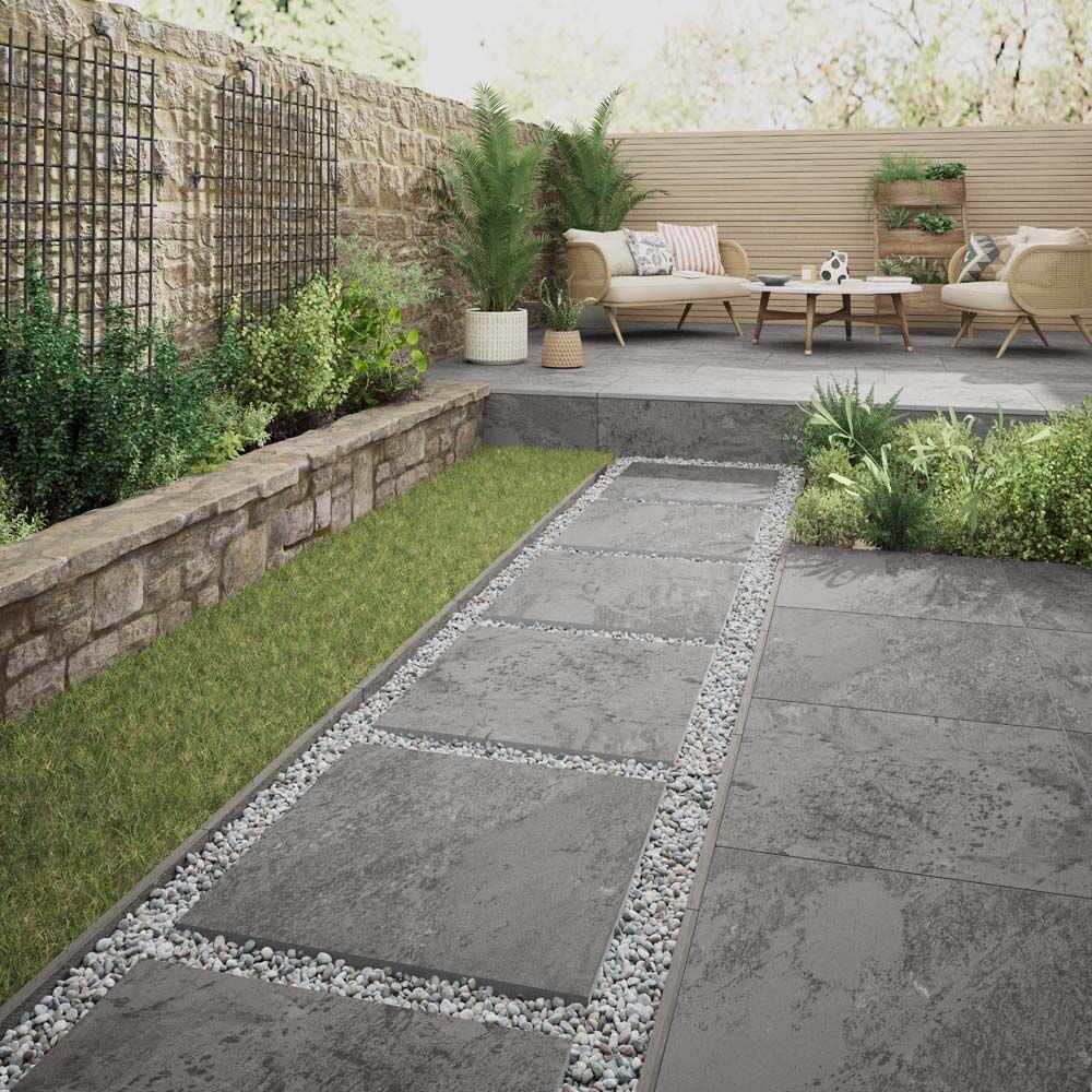Grey outdoor tiles laid across a landscaped garden patio