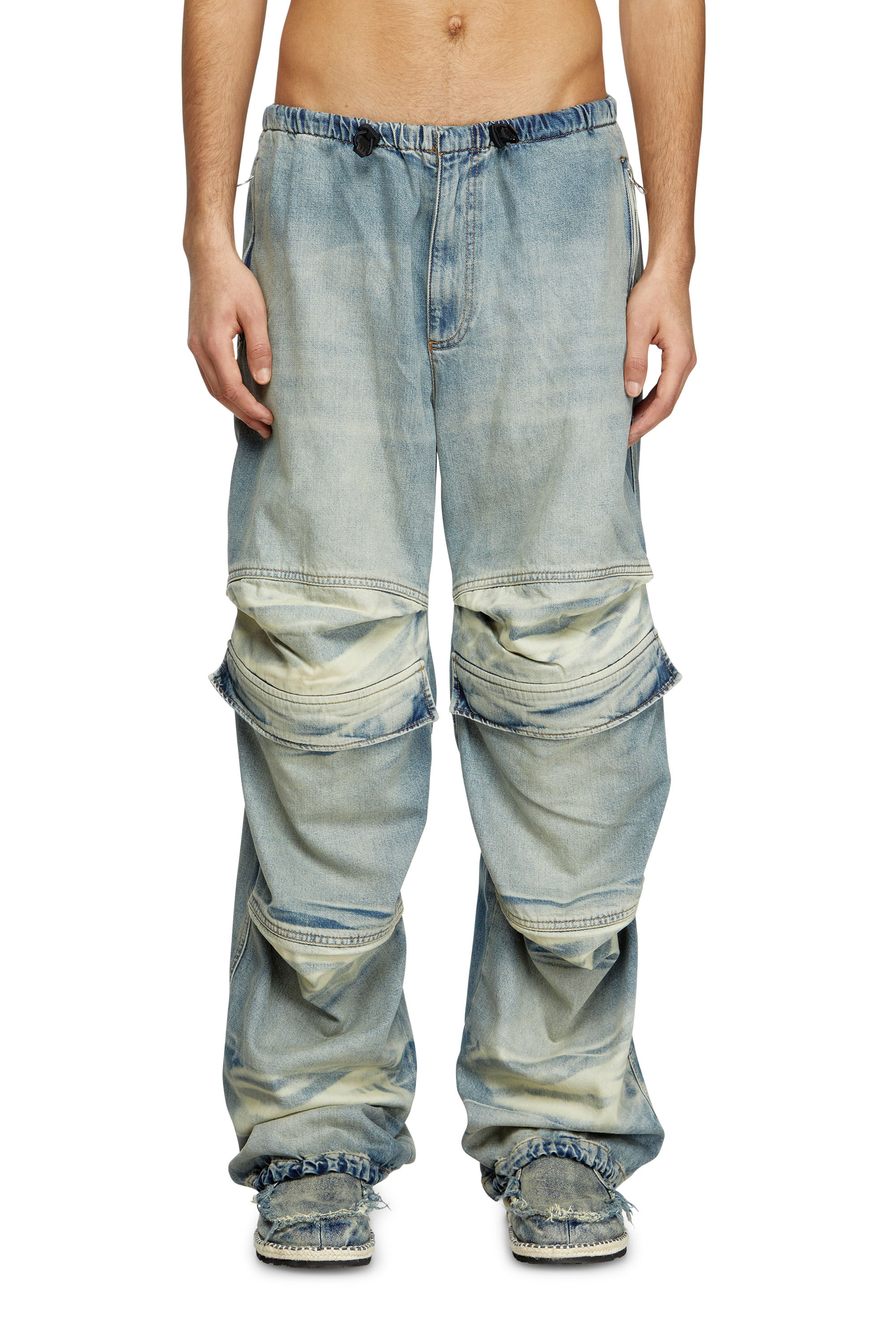 Model wearing light blue Diesel jeans against a white studio background