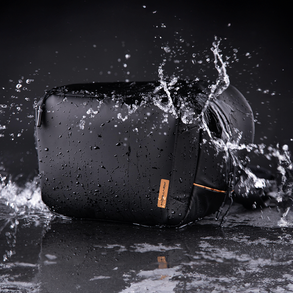 Black PGYTECH camera bag photographed against splashing water