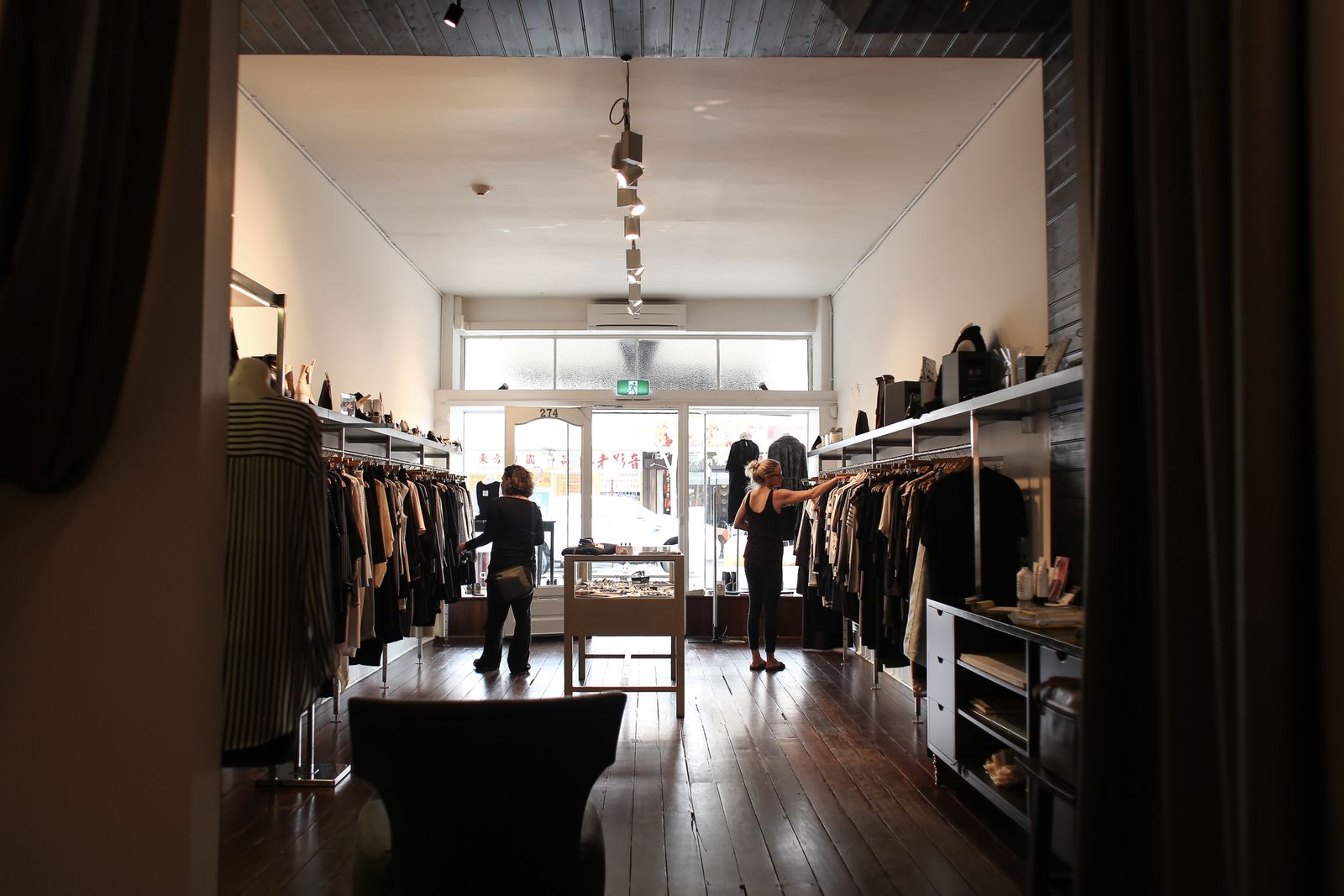 Customers browsing garments inside a clothing boutique
