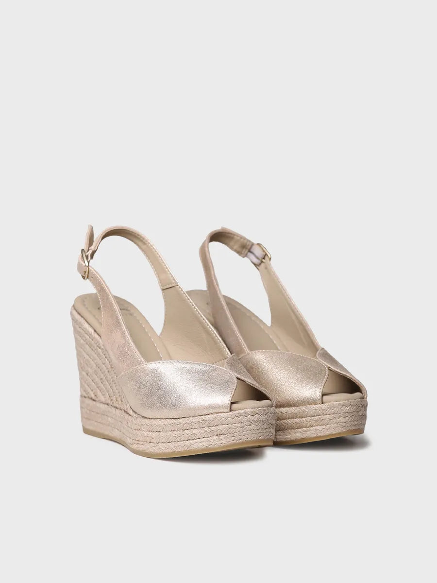 A pair of light-colored Toni Pons wedge espadrille sandals.