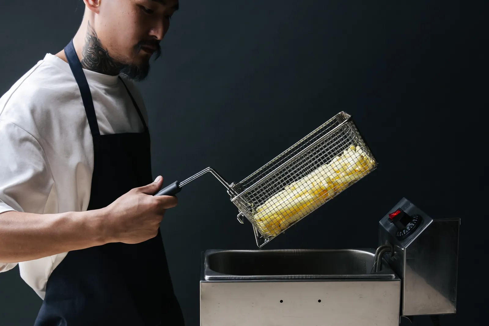 Chef preparing food in a fryer