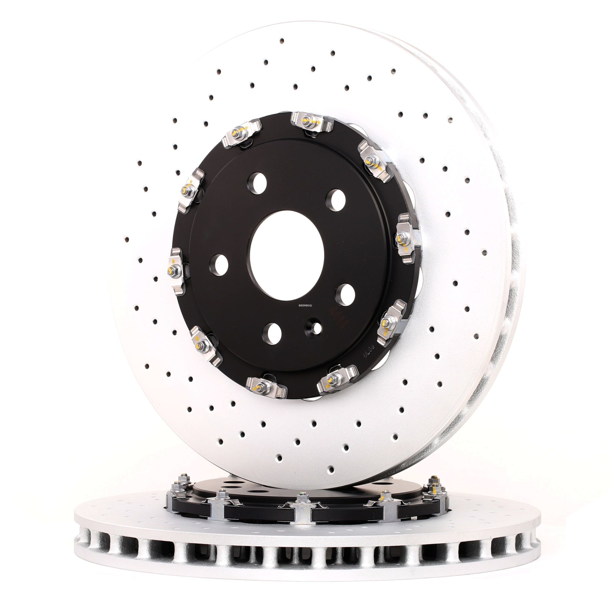 Three drilled automotive brake discs arranged upright on a white background