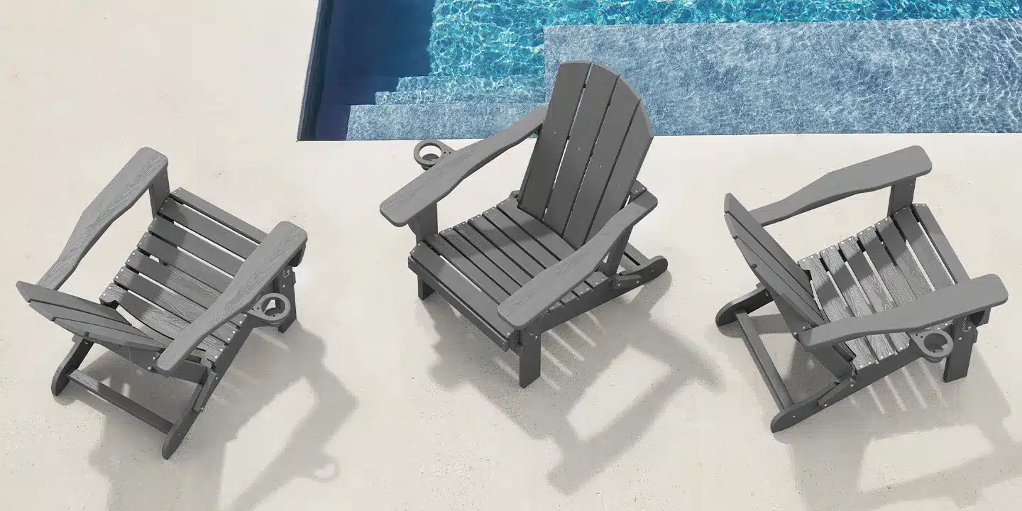 Three gray adjustable Adirondack chairs arranged beside a swimming pool