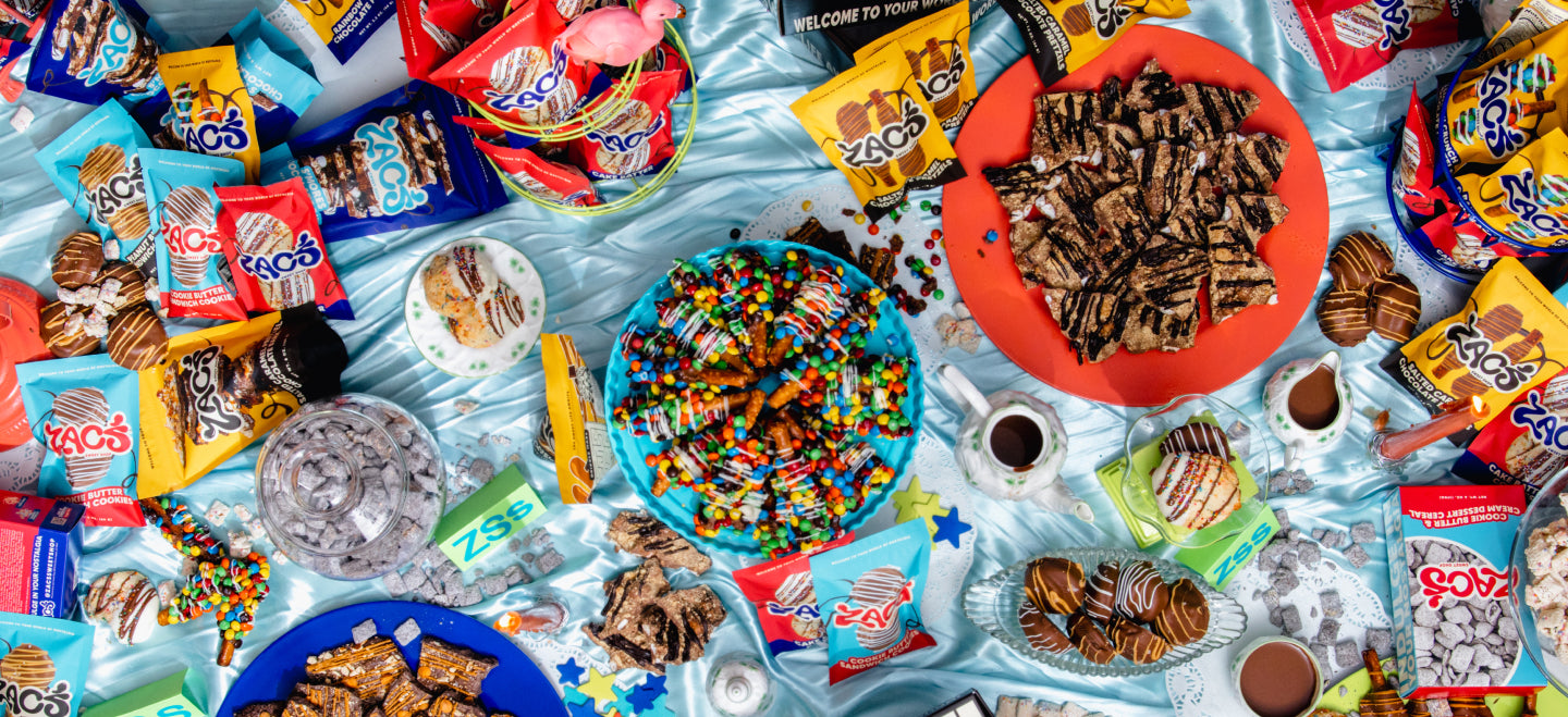 Colourful assortment of Zac's Sweet Shop packaged sweets, cookies, pretzels, and chocolate