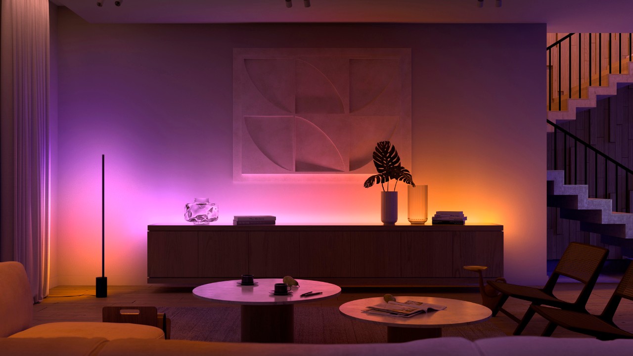 Modern living room illuminated with pink and amber Philips Hue smart lighting