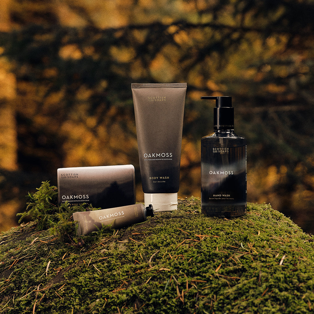 Scottish Fine Soaps Oakmoss grooming products arranged outdoors on moss
