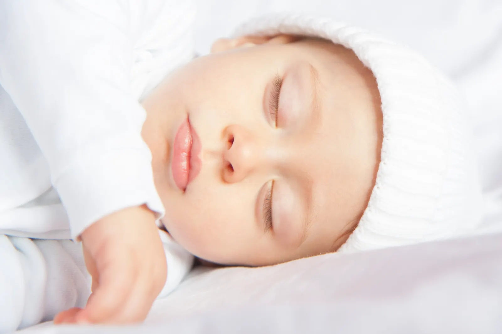 Baby sleeping peacefully under a soft blanket