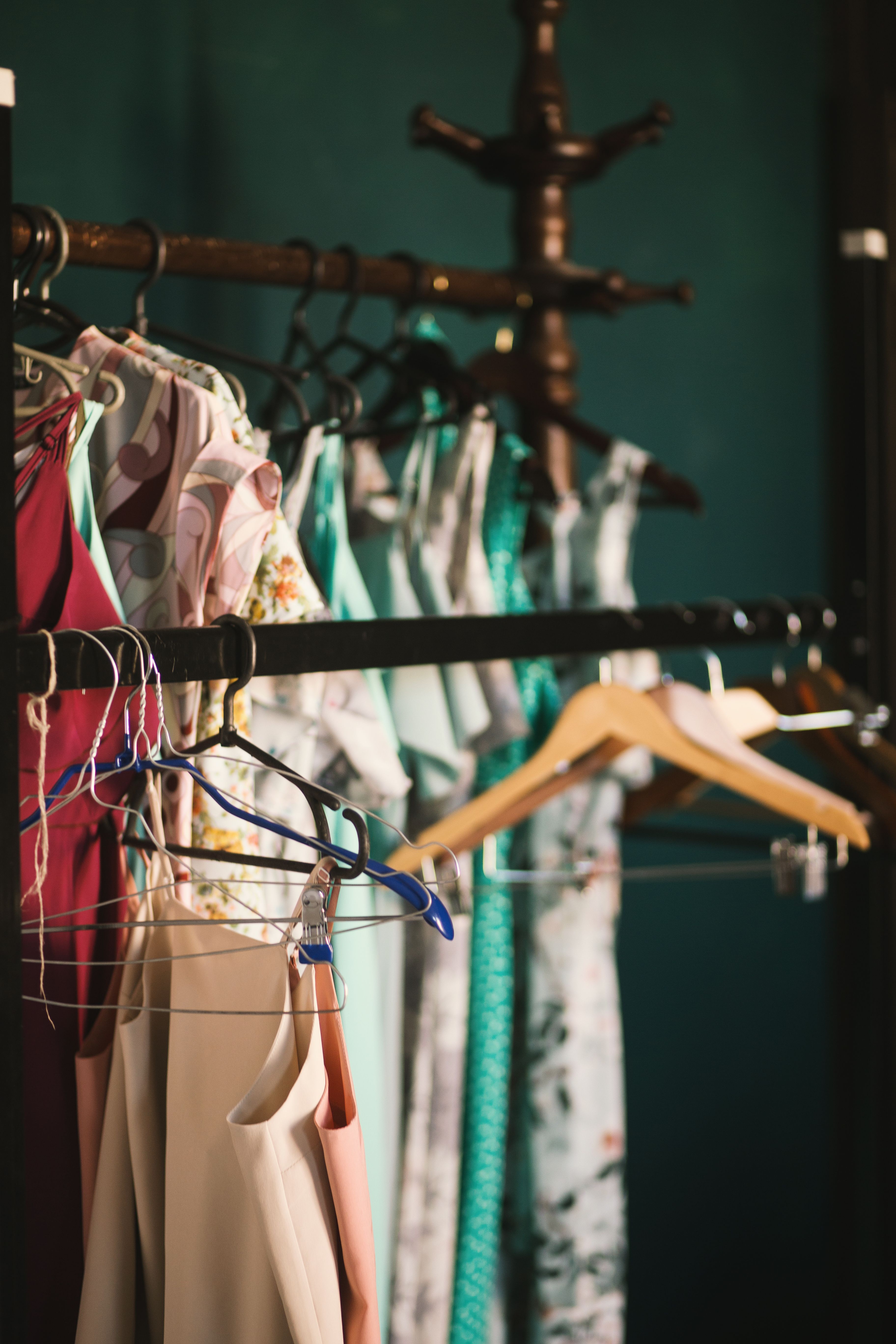 Assorted garments hanging from a rail in a clothing shop